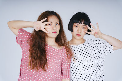 Portrait of lesbian couple against gray background