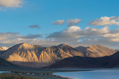 Scenic view of mountains against cloudy sky