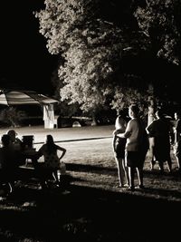 Rear view of people walking in park