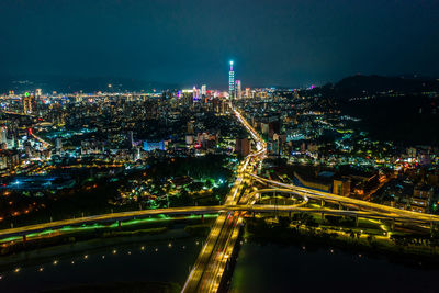 High angle view of illuminated city buildings at night