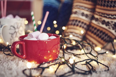 Close-up of drink with string lights on table