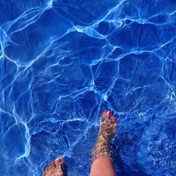 Low section of woman wading in water