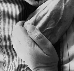 Close-up of woman hand on bed