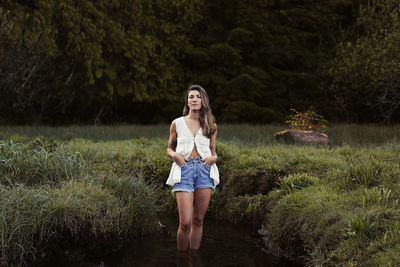 Natural beauty with tattoos in a meadow in ucluelet