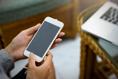 Midsection of man using mobile phone