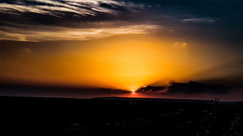 Scenic view of dramatic sky during sunset