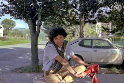 Side view of senior man riding motorcycle in park