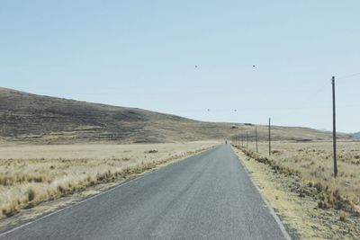 Country road passing through field