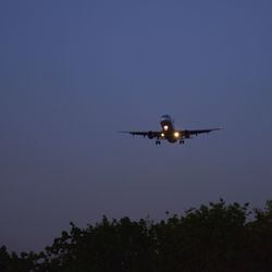 Low angle view of airplane against clear sky