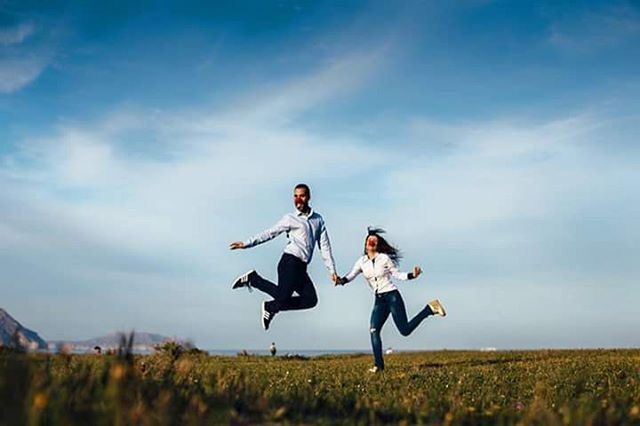 lifestyles, leisure activity, full length, field, sky, casual clothing, person, grass, childhood, landscape, boys, elementary age, mid-air, happiness, fun, young adult, enjoyment