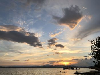 Scenic view of sea against dramatic sky during sunset