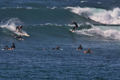 People surfing in sea