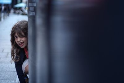 Portrait of smiling girl standing outdoors