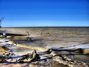 Scenic view of sea against clear blue sky