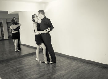 Full length of couple dancing at studio