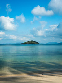 Scenic peaceful beach with clear turquoise seawater against cloud blue sky. koh mak island, thailand