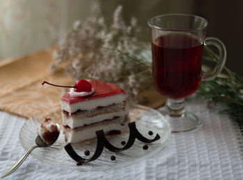 Close-up of drink with cake on table