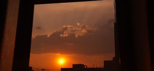 Low angle view of silhouette building against sky during sunset