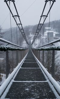 View of suspension bridge in foggy weather