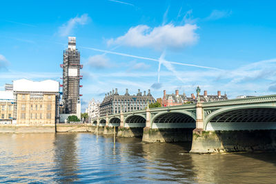 Bridge over river with city in background