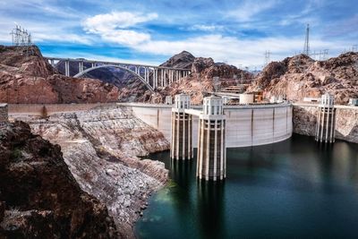 Dam by river against sky