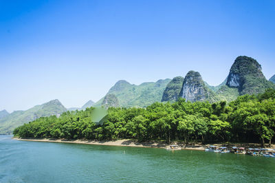 Scenic view of mountains against clear blue sky