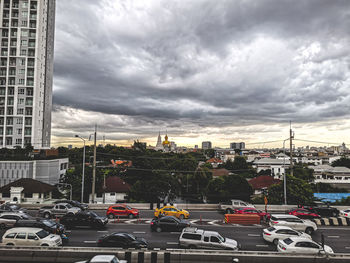 Vehicles on road against buildings in city