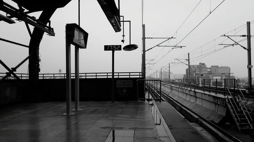 Empty railroad station platform against clear sky