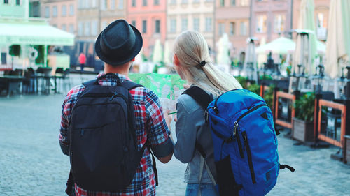 Rear view of people walking on street