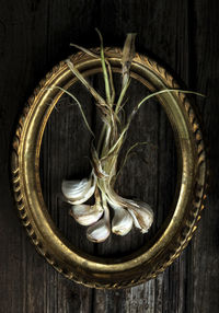Directly above shot of garlic with gold frame on table