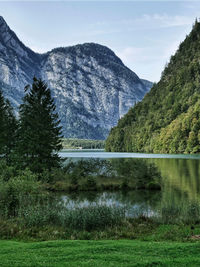 Scenic view of lake and mountains against sky