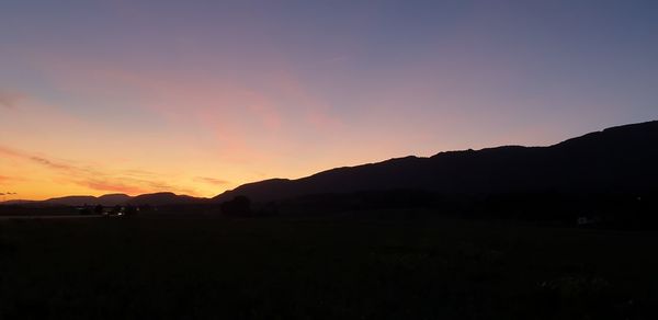 Scenic view of silhouette mountains against sky during sunset
