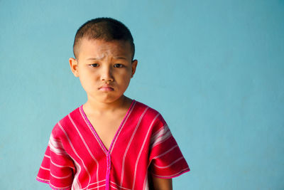 Boy against blue background