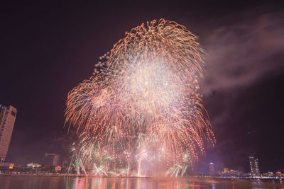 Low angle view of firework display at night