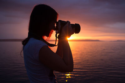 Silhouette of photographer at sunset