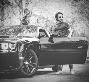 Portrait of man sitting on car