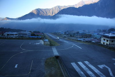 Aerial view of city and mountains against sky