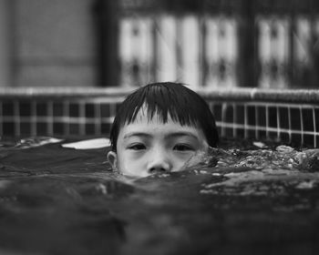 Portrait of cute boy swimming in pool