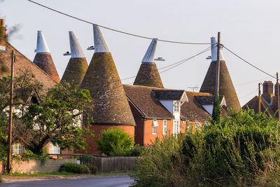 Traditional building by trees against sky