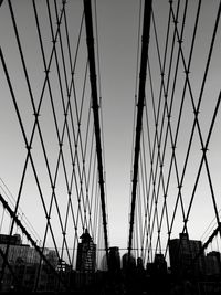 Low angle view of suspension bridge against sky