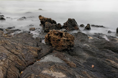 Rocks on shore against sea