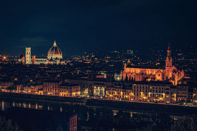 Illuminated buildings in city at night