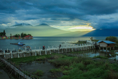 Scenic view of lake against sky at sunset