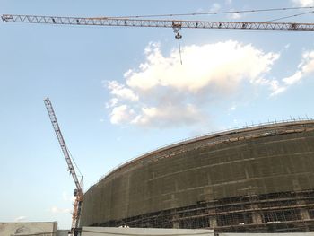 Low angle view of crane against sky