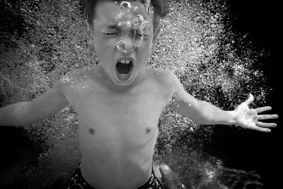 Portrait of shirtless boy standing in water