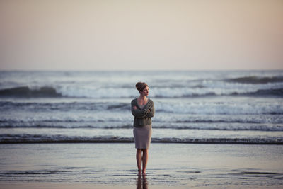 Beautiful woman on long beach at sunset in tofino