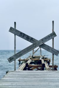 Pier by sea against clear sky