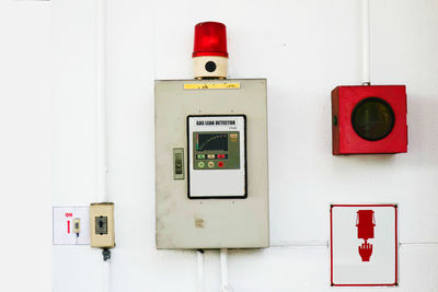 Close-up of safety equipment on white wall