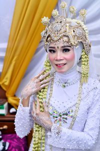 Portrait of young woman wearing traditional dress and smiling looking at camera 