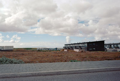 Built structures against cloudy sky